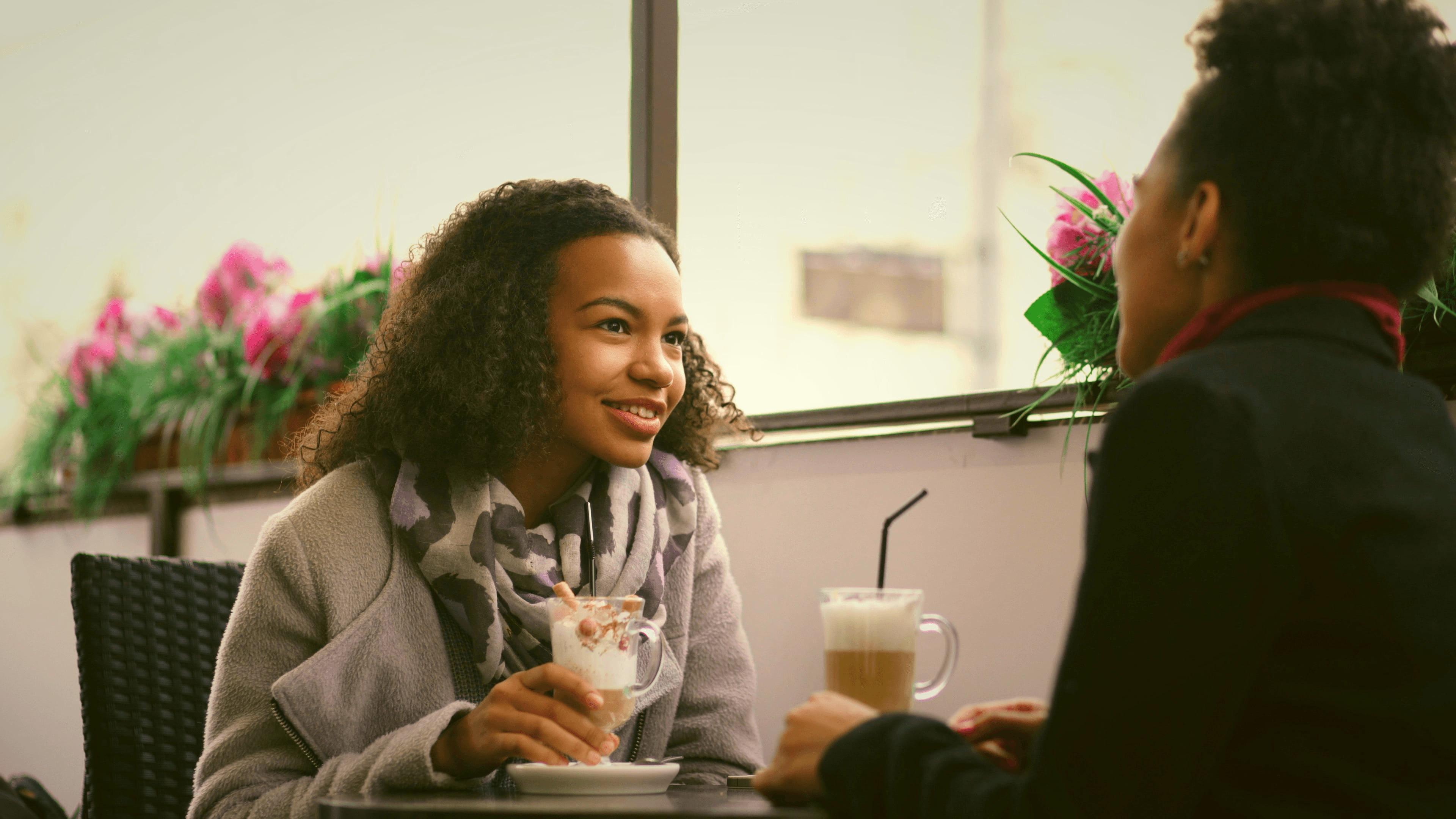 Two young professionals chatting over coffee