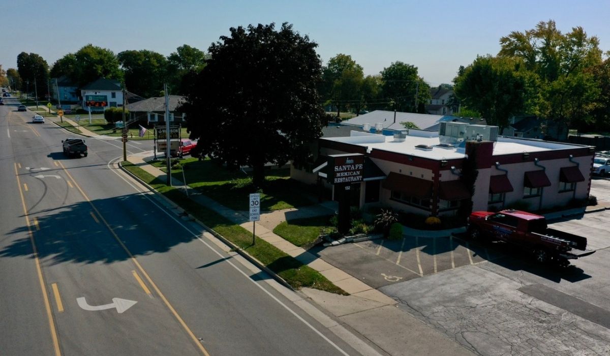 Original aerial photo of an Illinois commercial property with a low-slope roof and rooftop mechanical equipment. Used to support the article’s discussion of commercial roof maintenance and seasonal inspection priorities before winter.