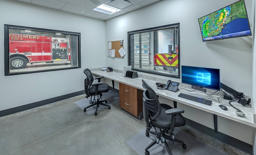 Dispatch desk with weather monitor at MCESD 2 Fire Station 55, by Martinez Architects.