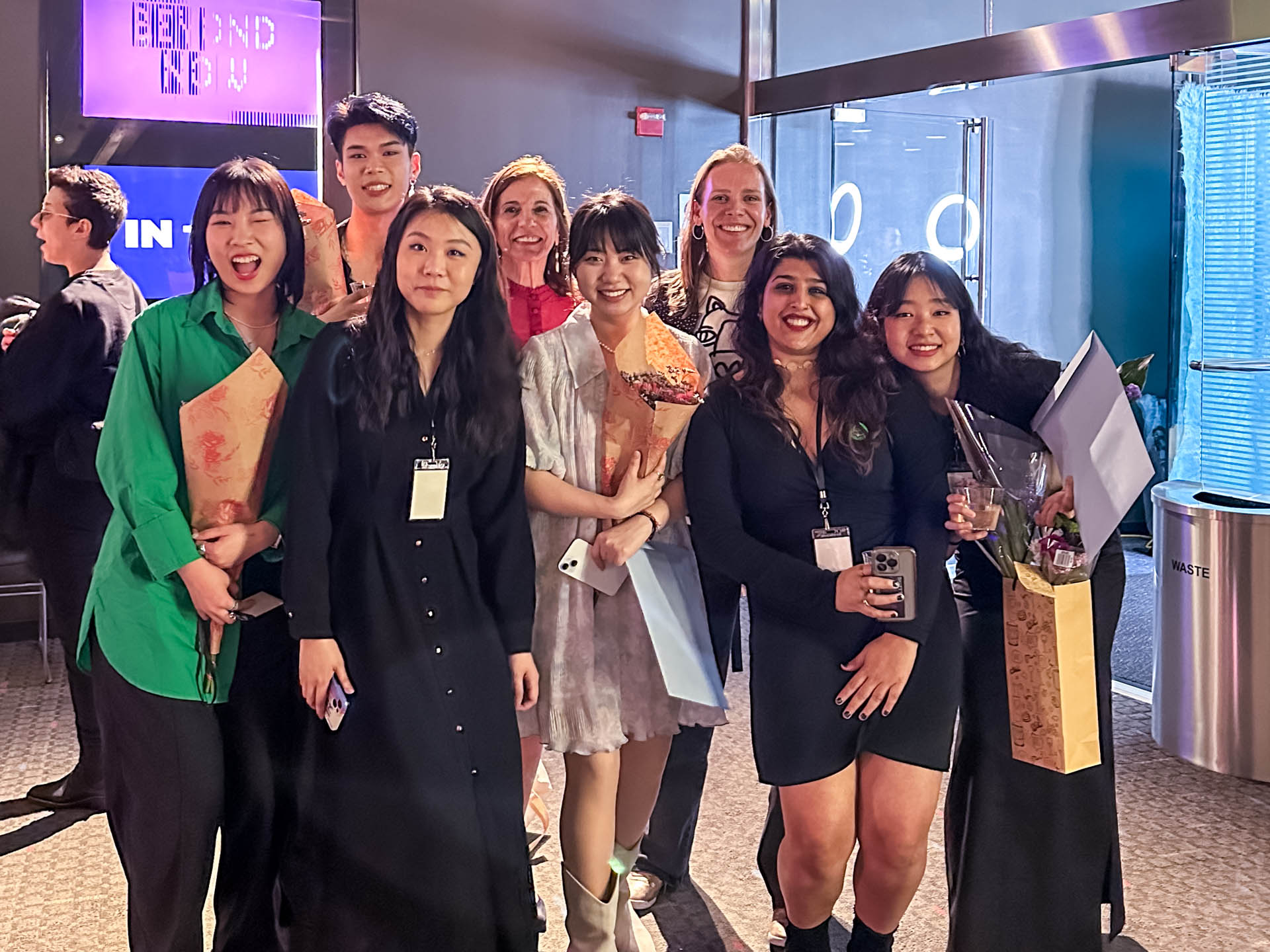 a group of students smiling for the camera in the SVA Theatre lobby after the Venture Forum