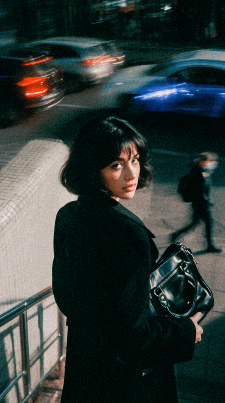 Female model wearing corporate clothes standing in the middle of the street with a motion blur backgorund