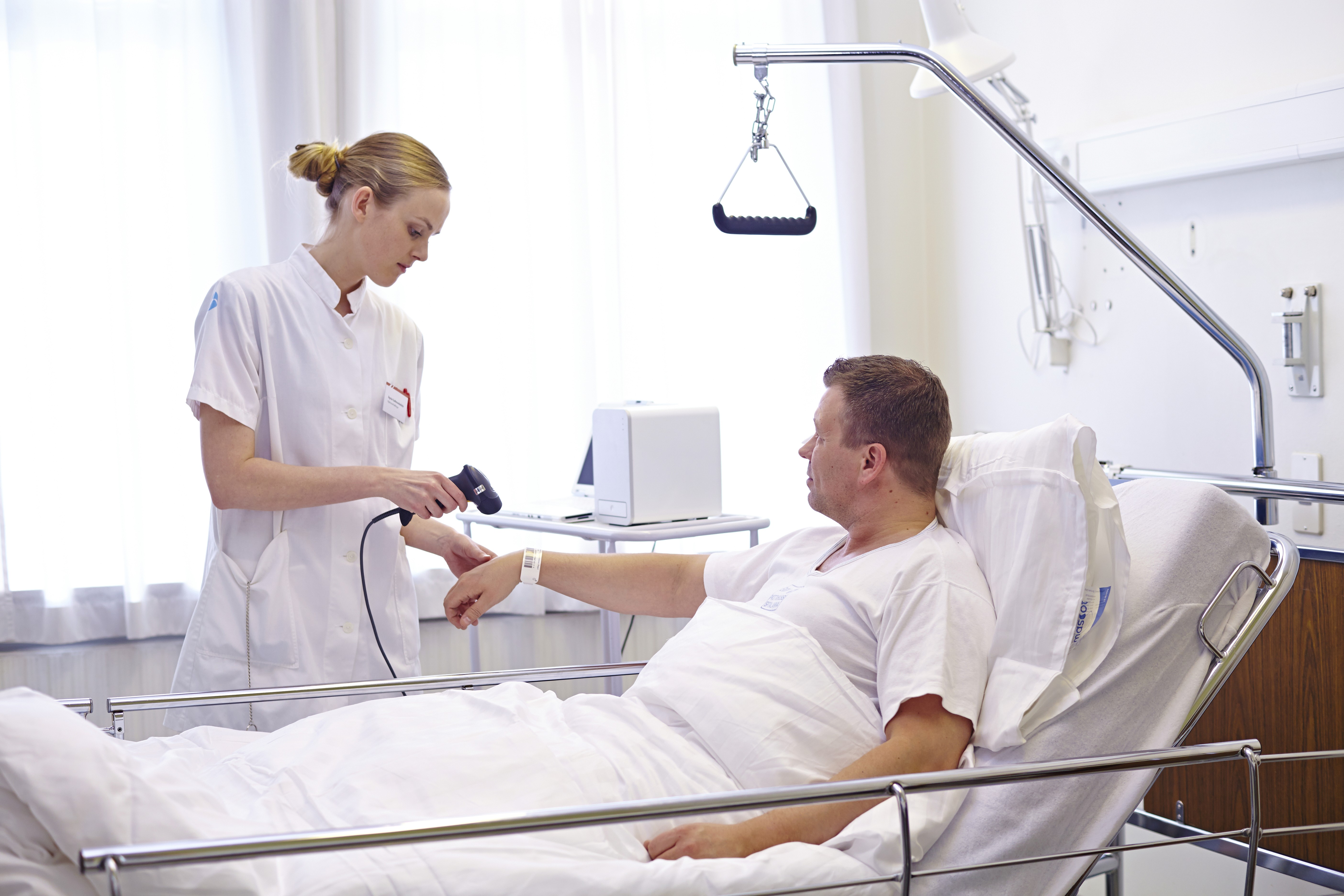 a gloved hand holding a test tube filled with liquid
