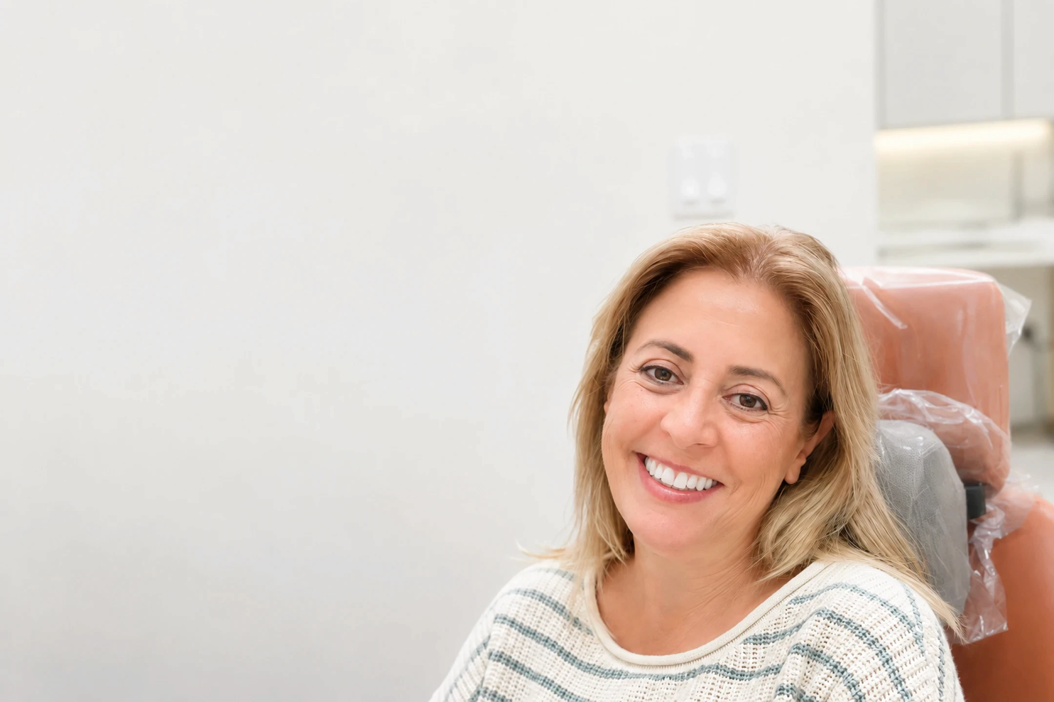 lleveza patient smiling after full-arch dental implant treatment