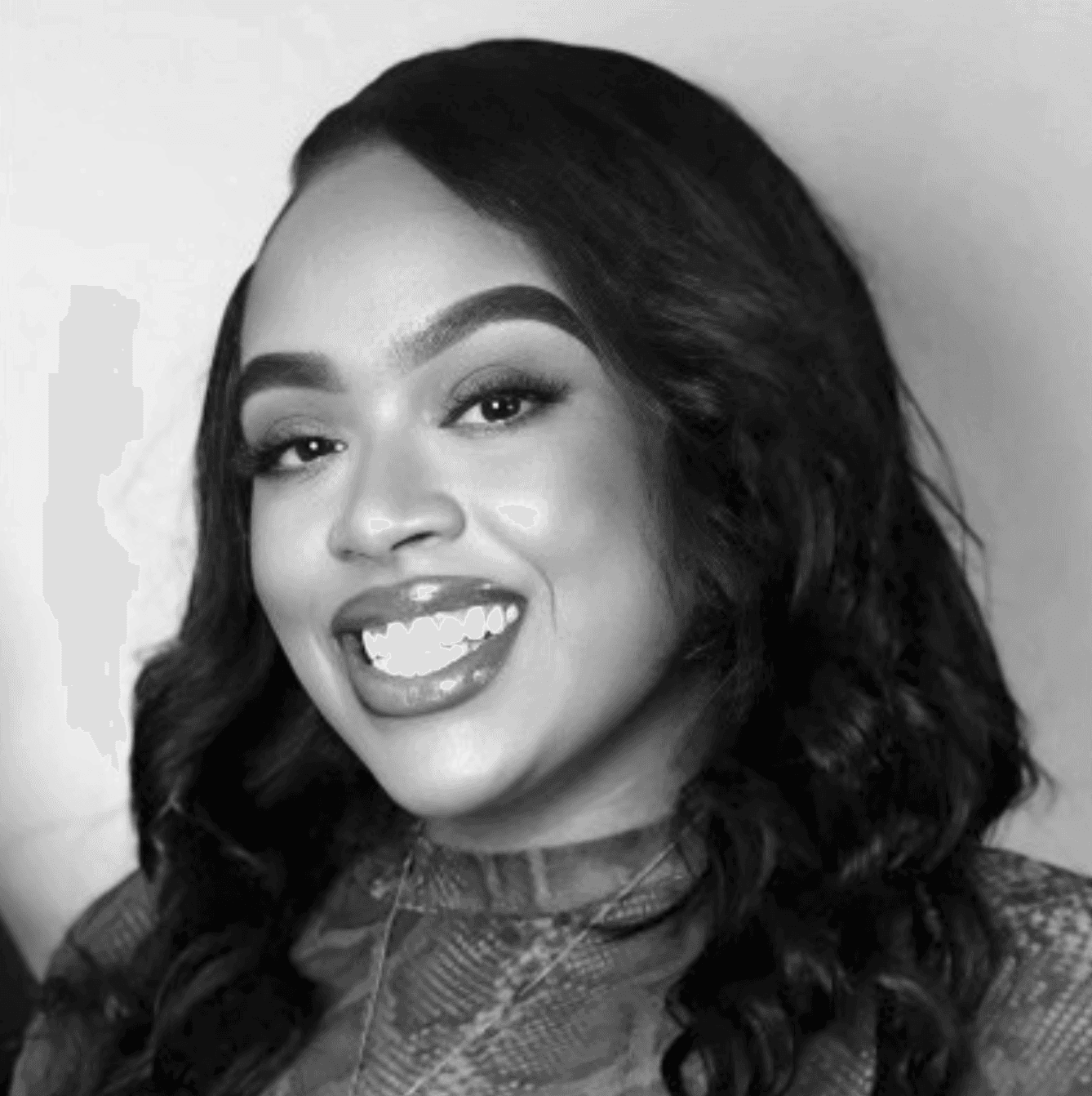 Young man in a tweed jacket and patterned silk scarf.