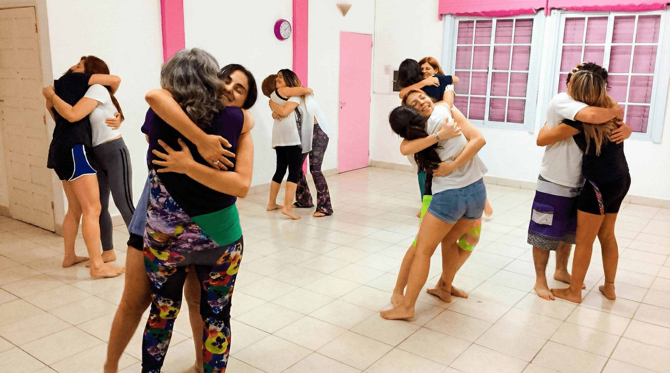Table with open book, tea and pillows spread around