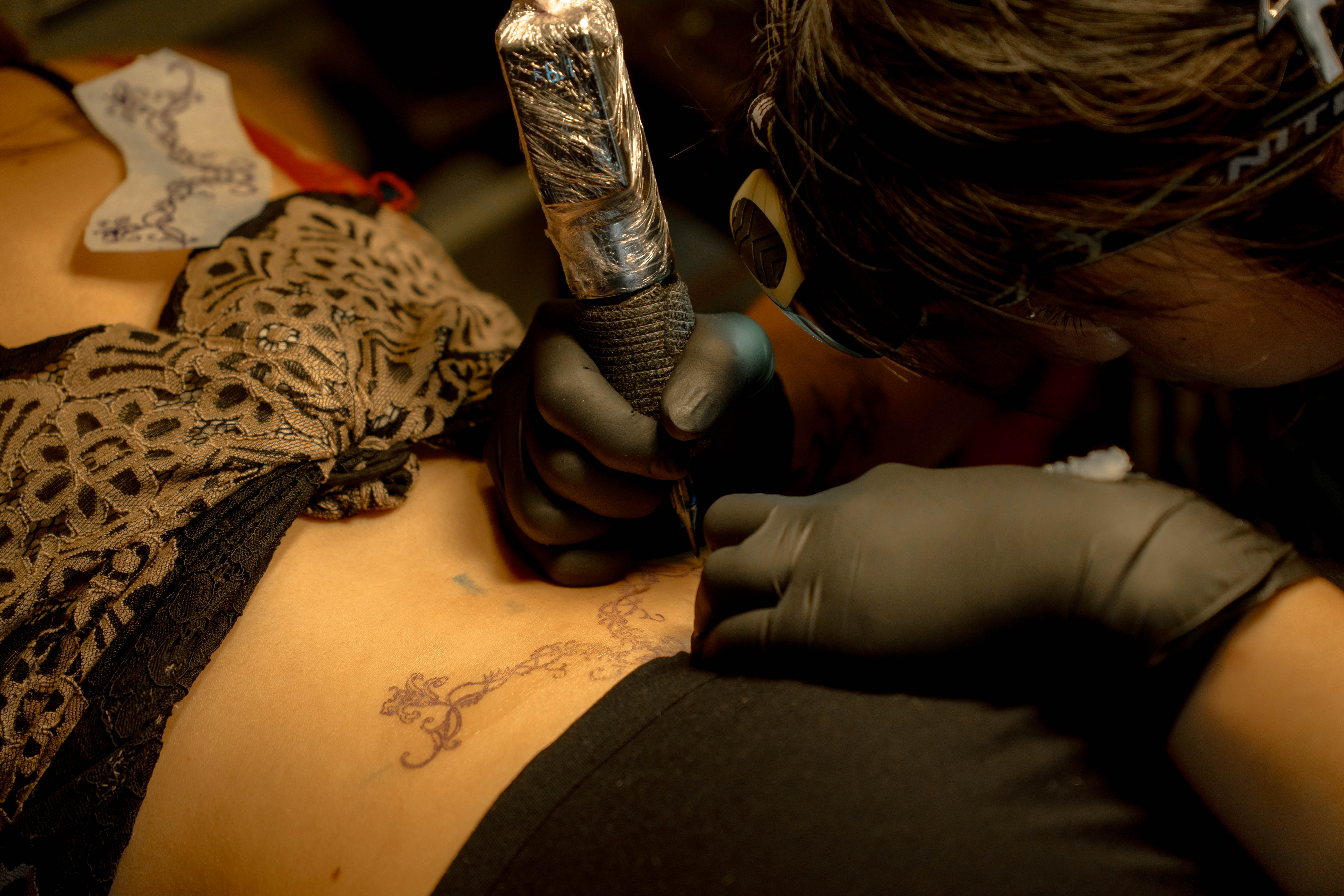 Tattoo artist at work captured in a cinematic portrait by Studio 222