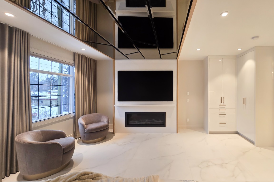 Image of Modern living room interior design with marble floor, built-in TV, fireplace, and custom cabinetry by KHD Homes.