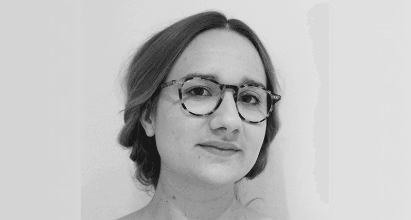 A black and white photo of a girl wearing glasses.