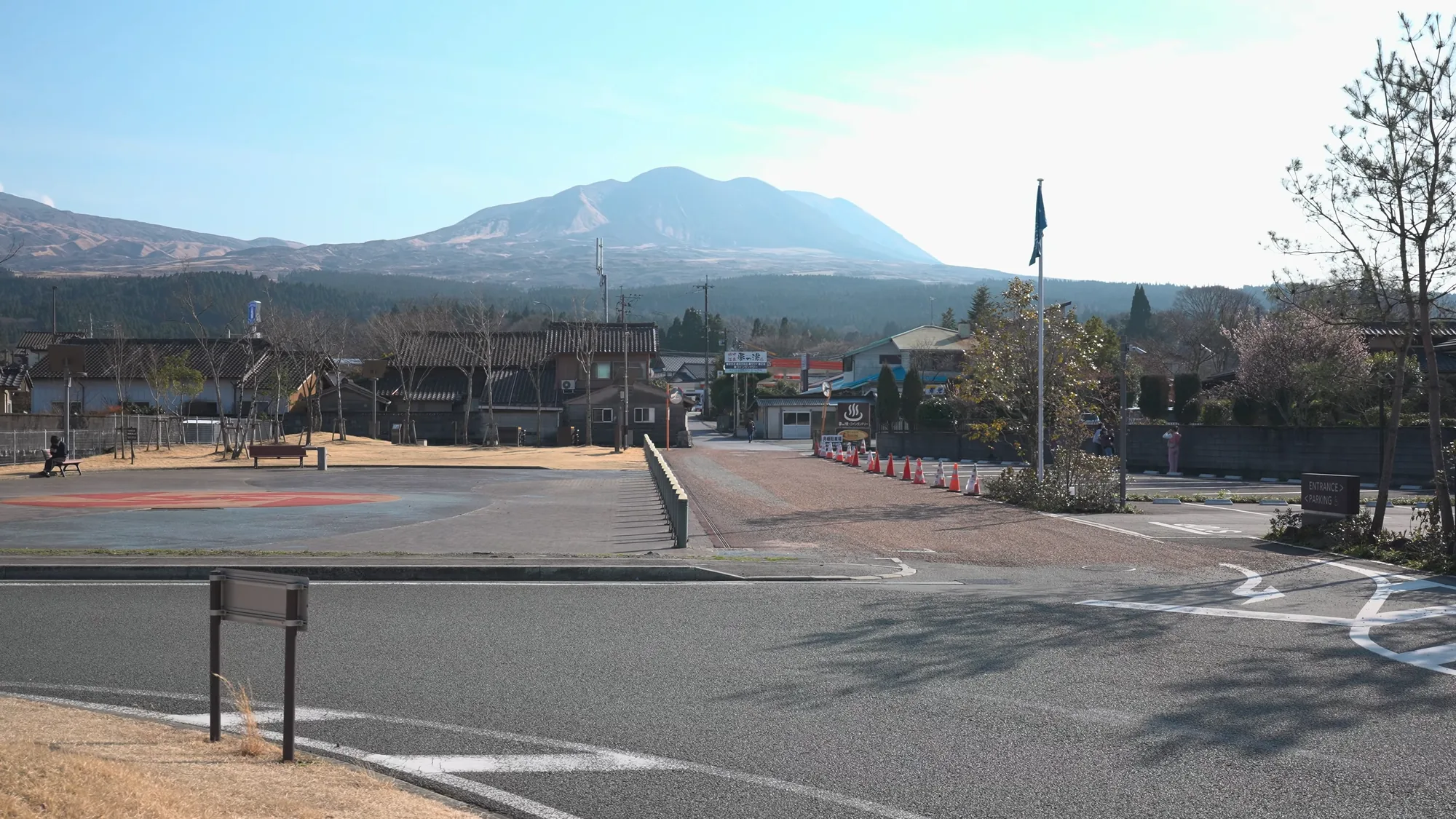 A wide forecourt with the Aso caldera rim beyond, near Kurokawa Onsen