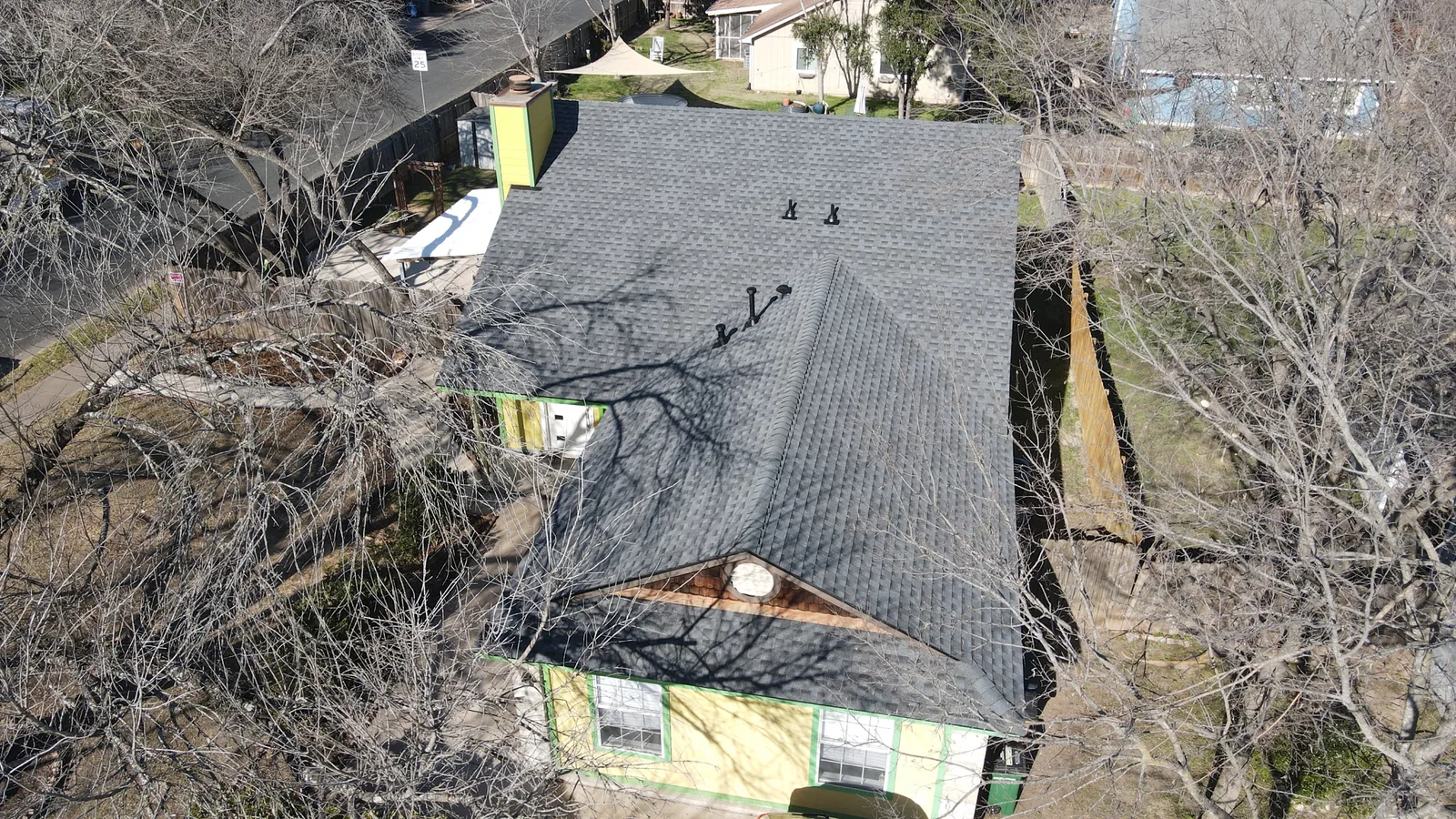 After - another angle: charcoal shingles and a yellow chimney.