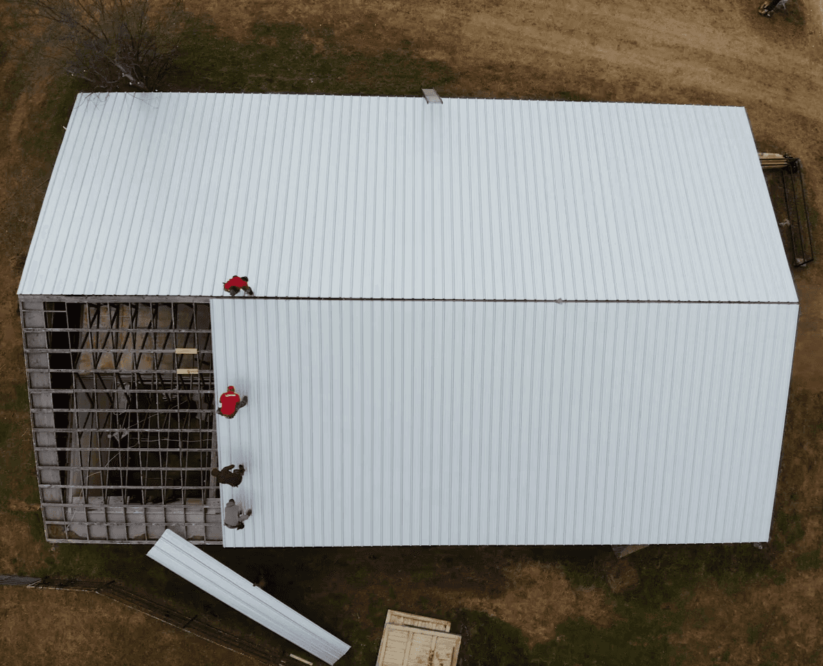 After photos of a large barn with a new Corrugated metal roof panel. 