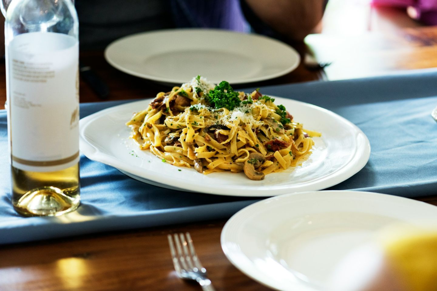 Fresh pasta with mushrooms, herbs, and grated cheese served at a restaurant in Reykjavík.