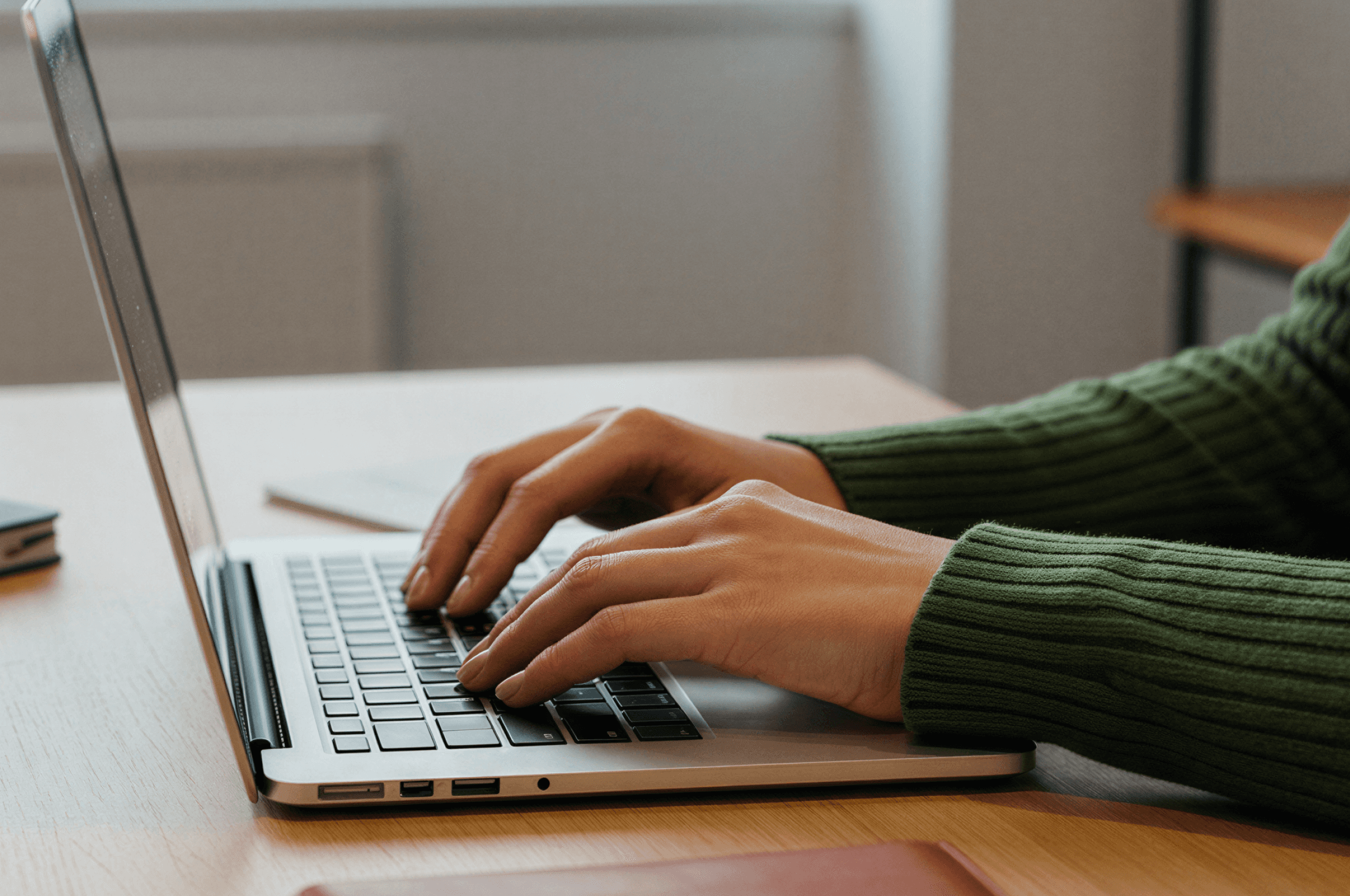 a laptop computer sitting on top of a wooden table