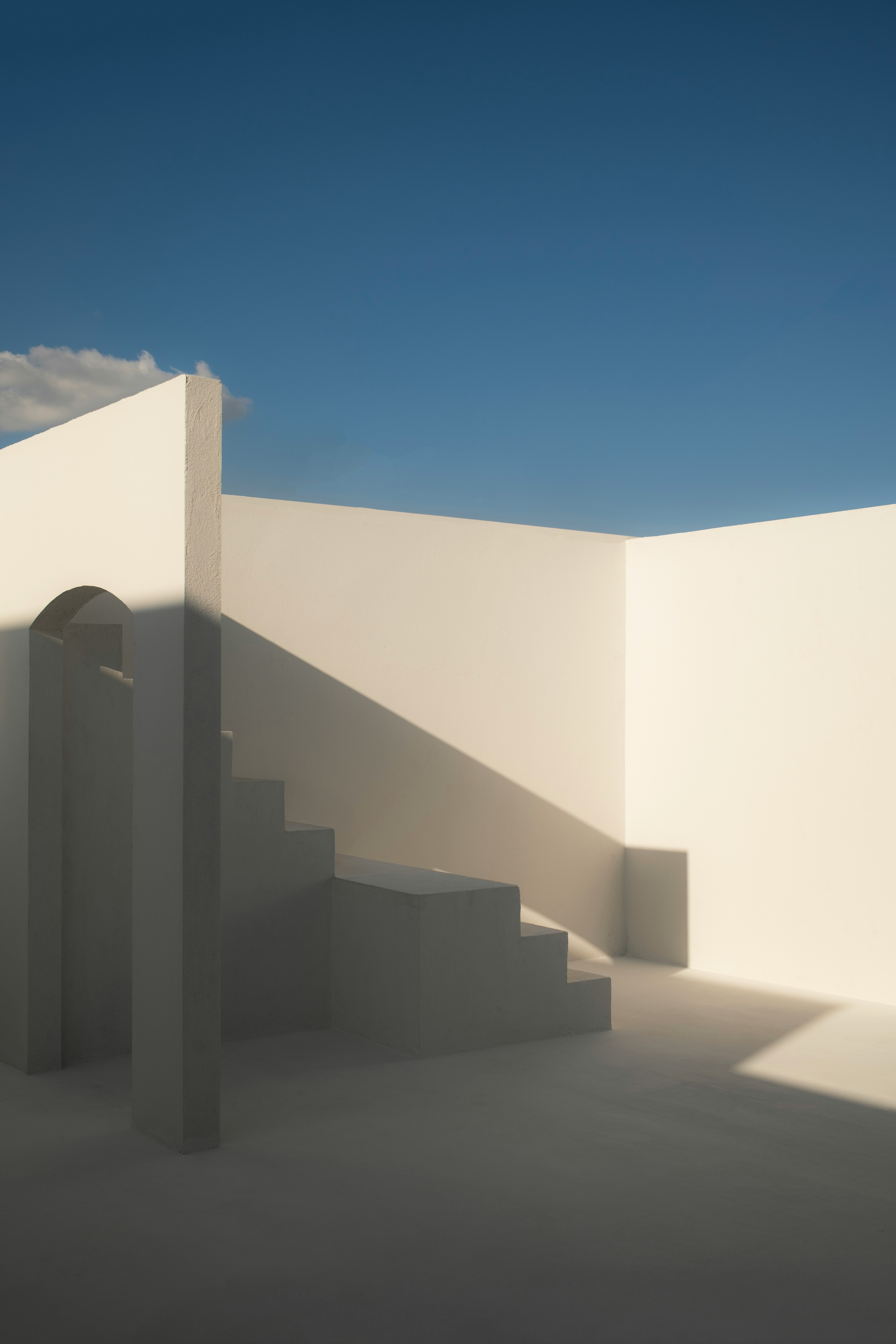 White architectural structure with stairs and blue sky