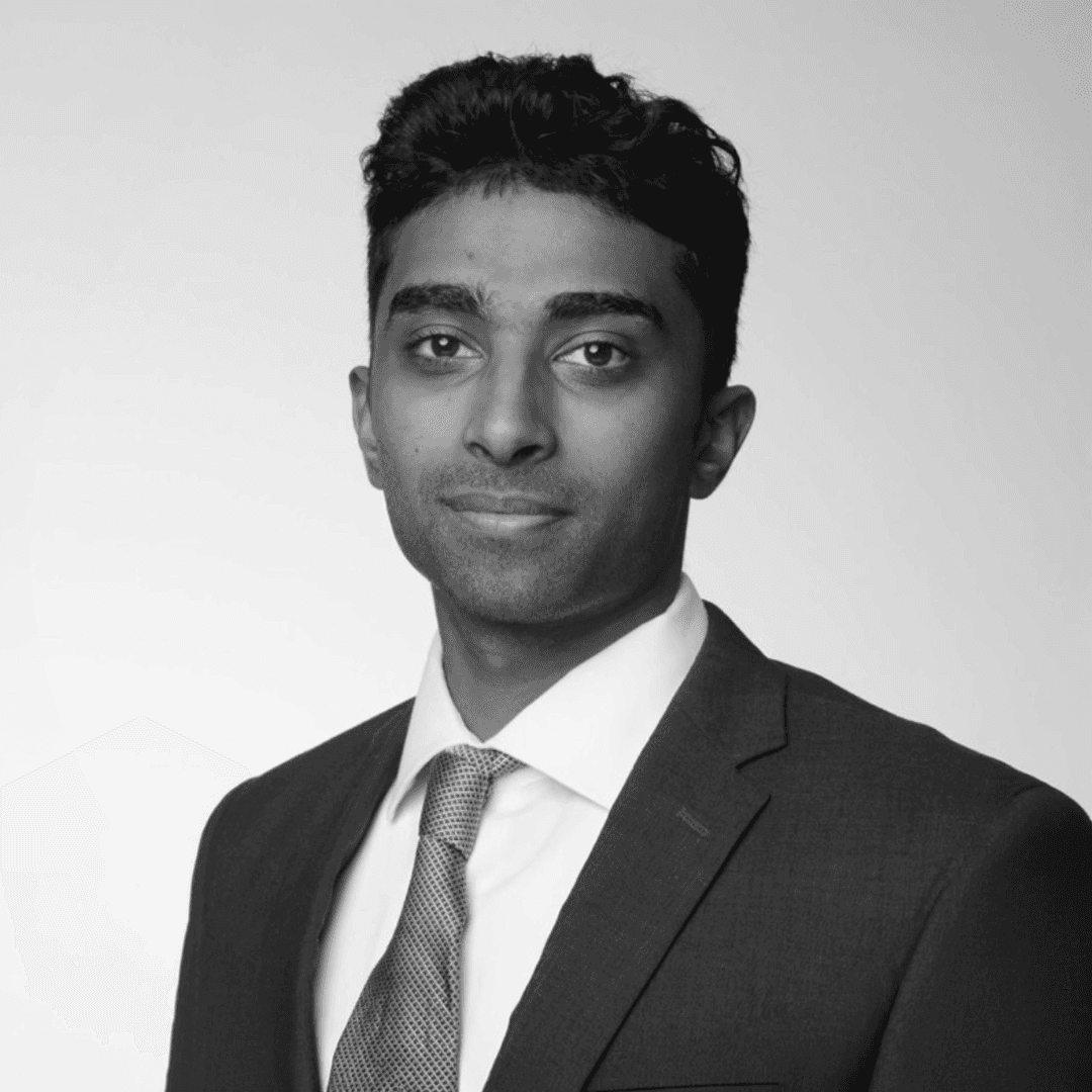 man in suit jacket sitting down