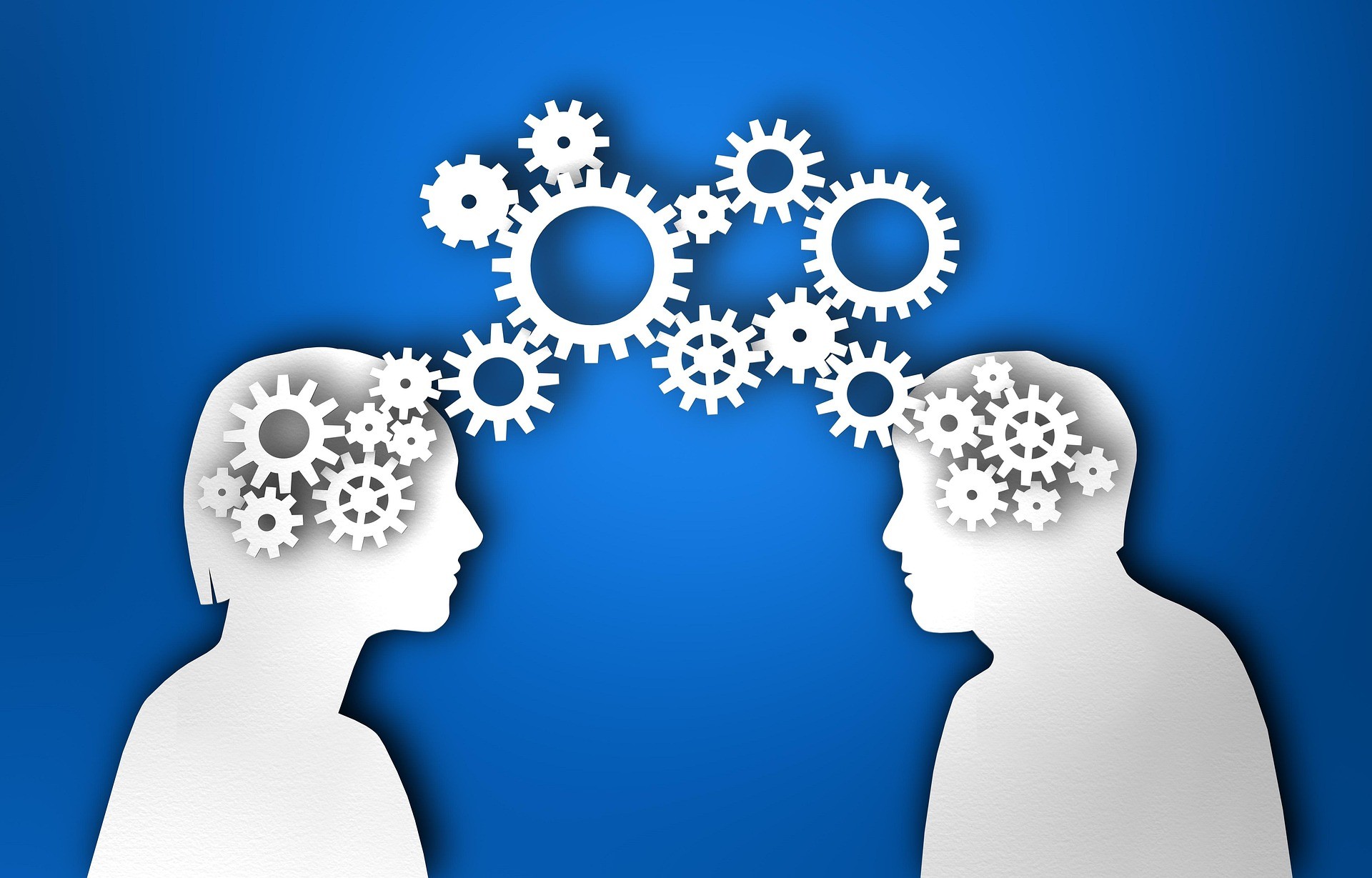 two hands touching each other in front of a blue background