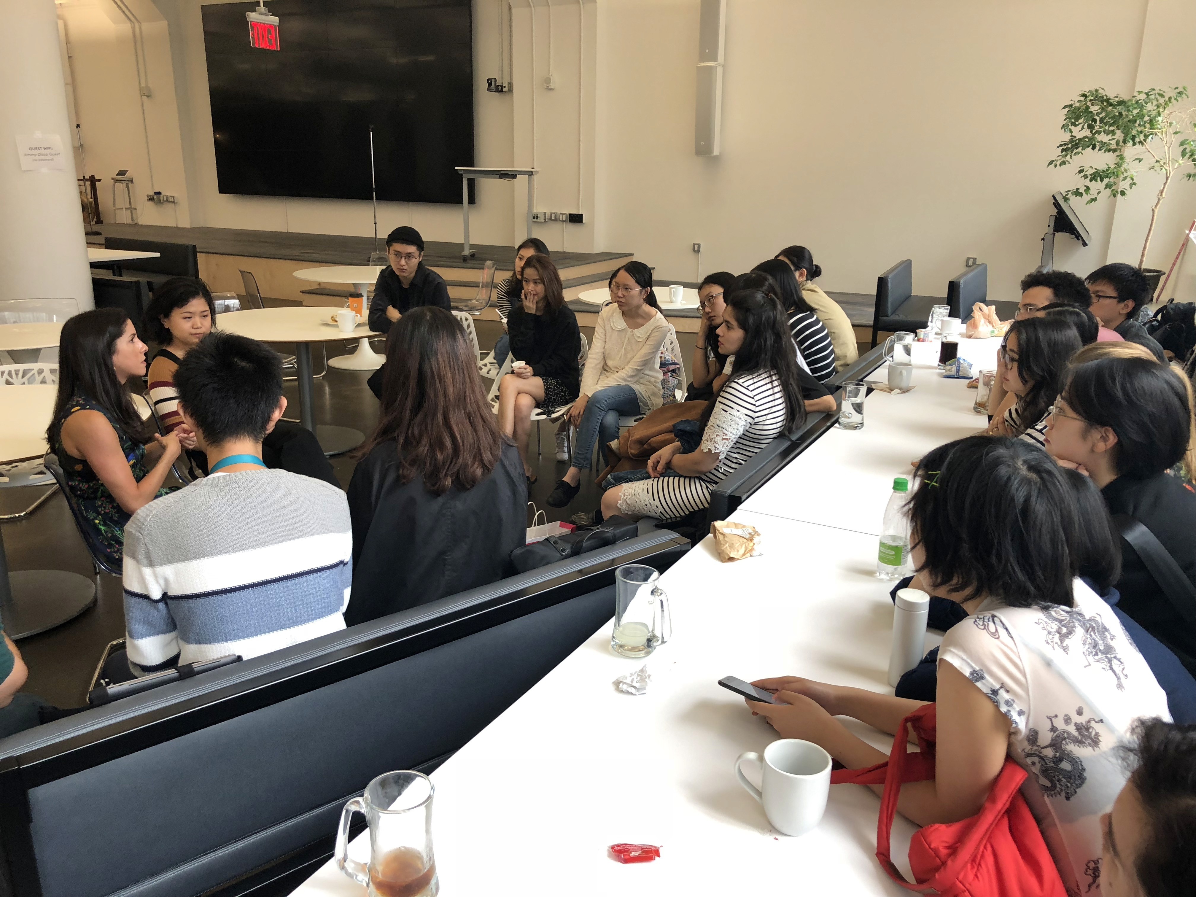People gathered in a meeting room and chatting.
