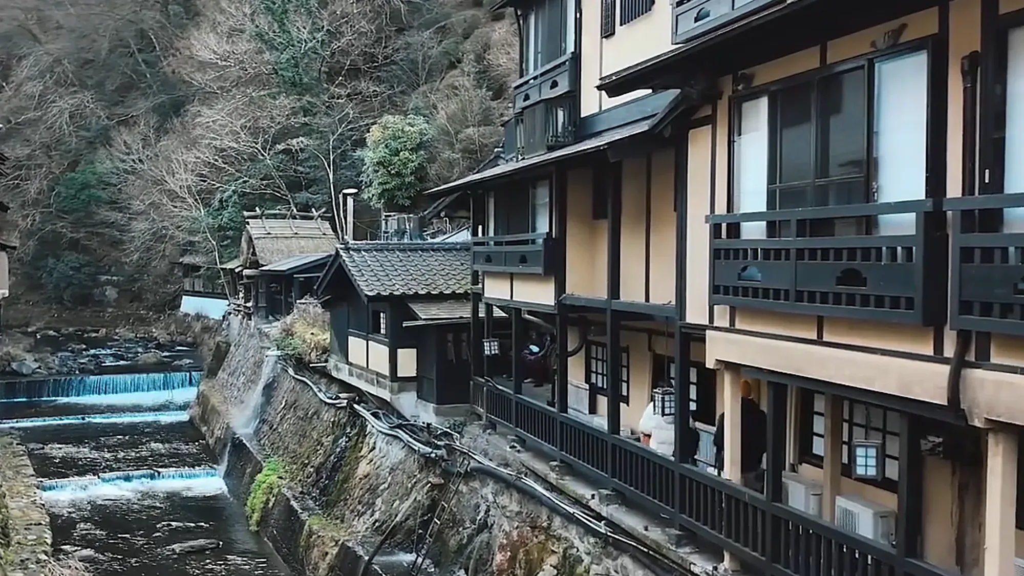 Timber inns standing above the channelled river at Kurokawa Onsen