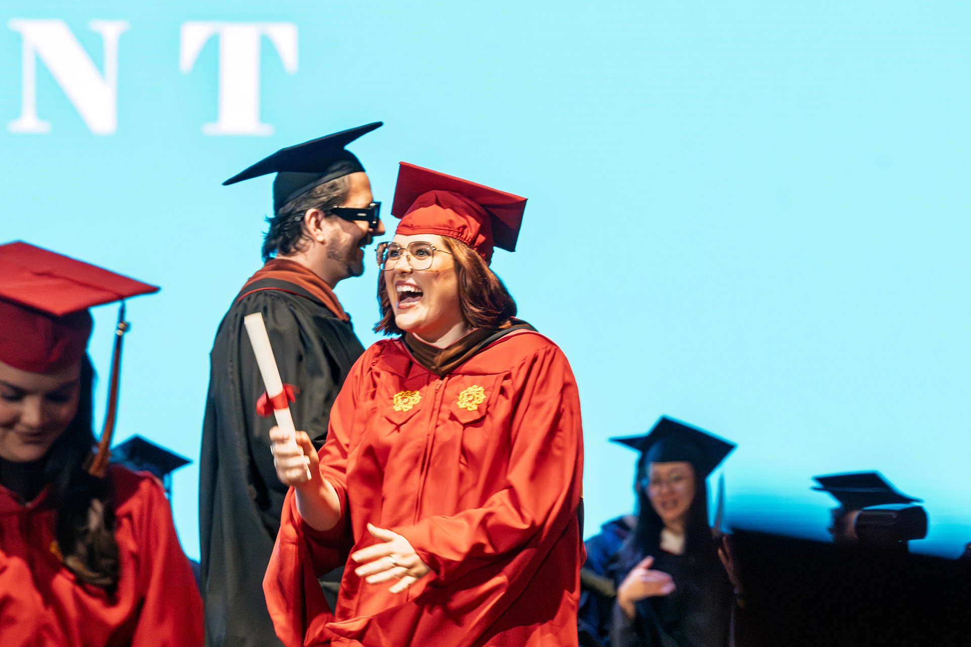 a student on stage getting her diploma