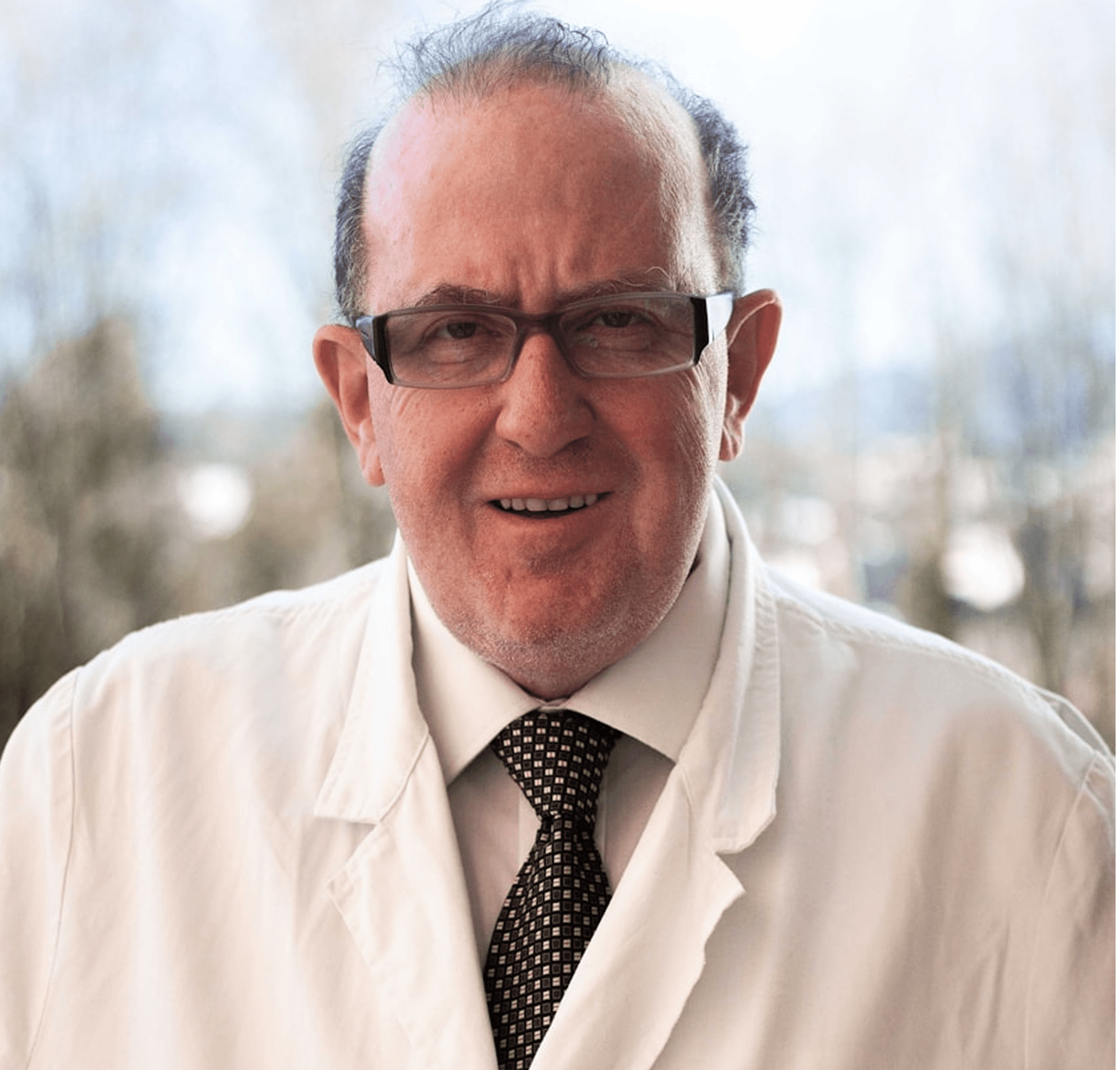 Older professional in white coat and tie standing outdoors