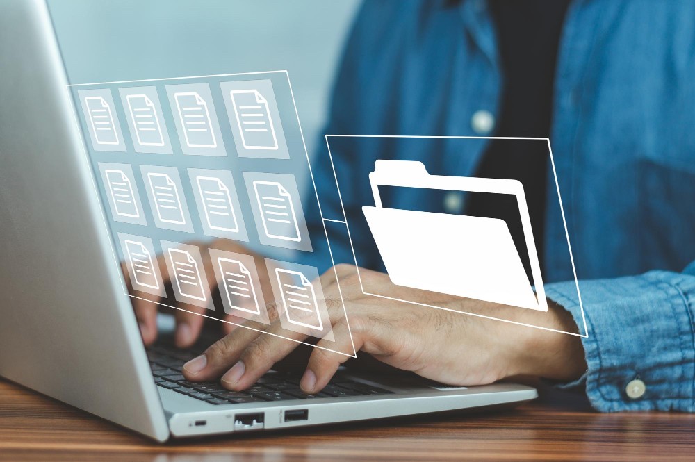 Business professional accessing digital folders and documents on a transparent screen, symbolising automated document management.