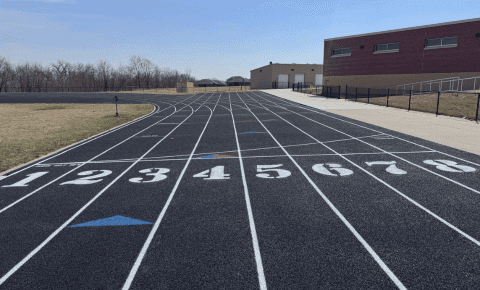 Resurfaced running track with clean lane markings and smooth black surface at Elkhorn Valley View Middle School in Nebraska