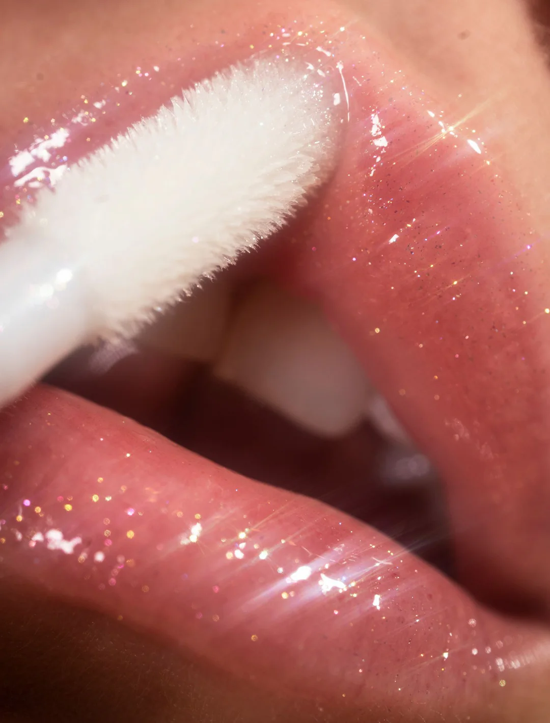 Two women in front of a computer with one operating it and the other one looking