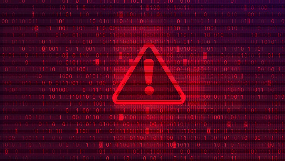 Red digital warning symbol glowing on a circuit board interface, representing active ransomware exploitation of the VMware ESXi CVE 2025 22225 vulnerability and hypervisor compromise.