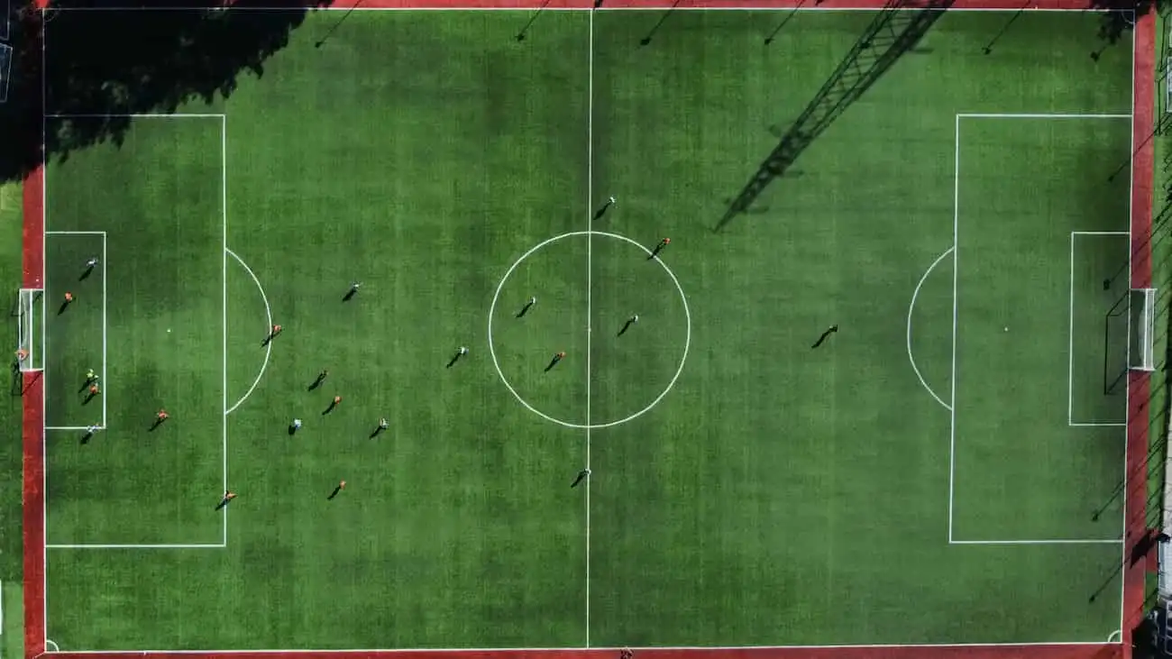 Aerial view of a football pitch during a match, ideal for tournament planning with CoachingArea.