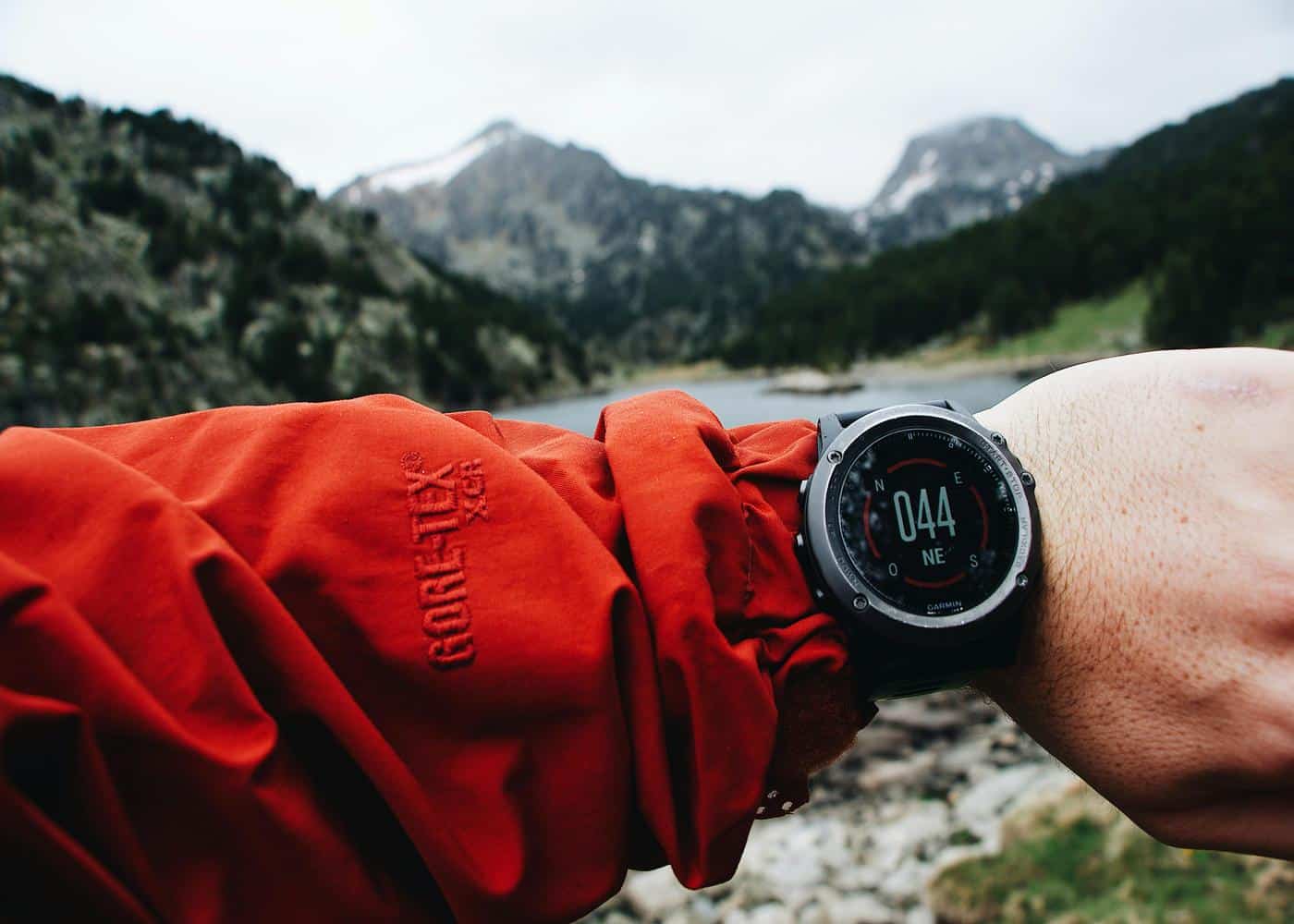 Person outdoors looking at garmin watch to showcase an apple fitness alternative