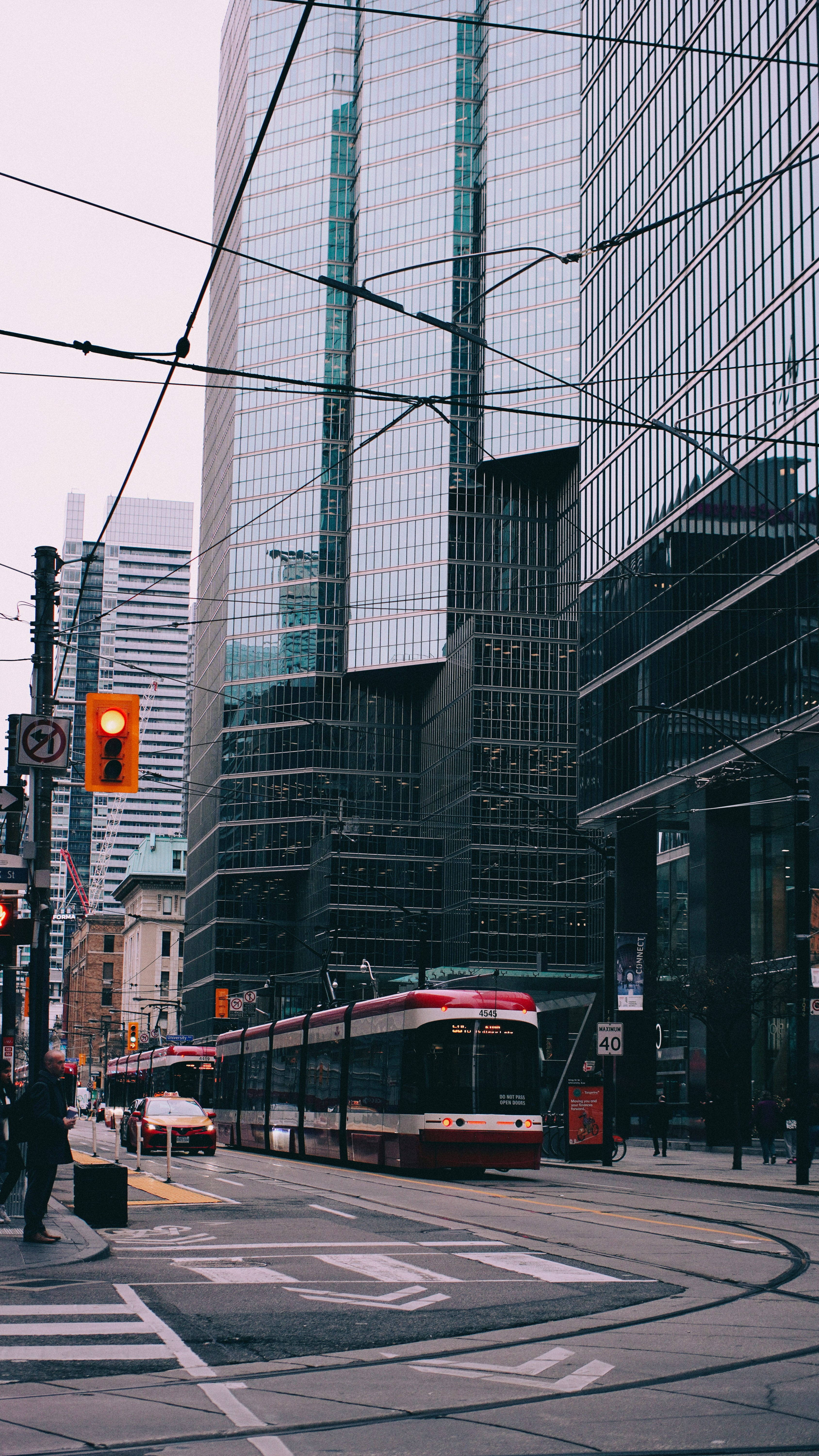 A city street filled with traffic next to tall buildings