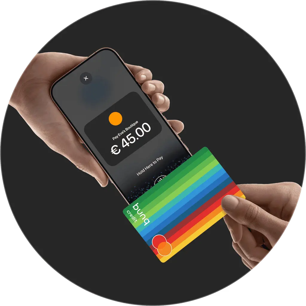 Person holding a smartphone with a credit card tapped on top of it