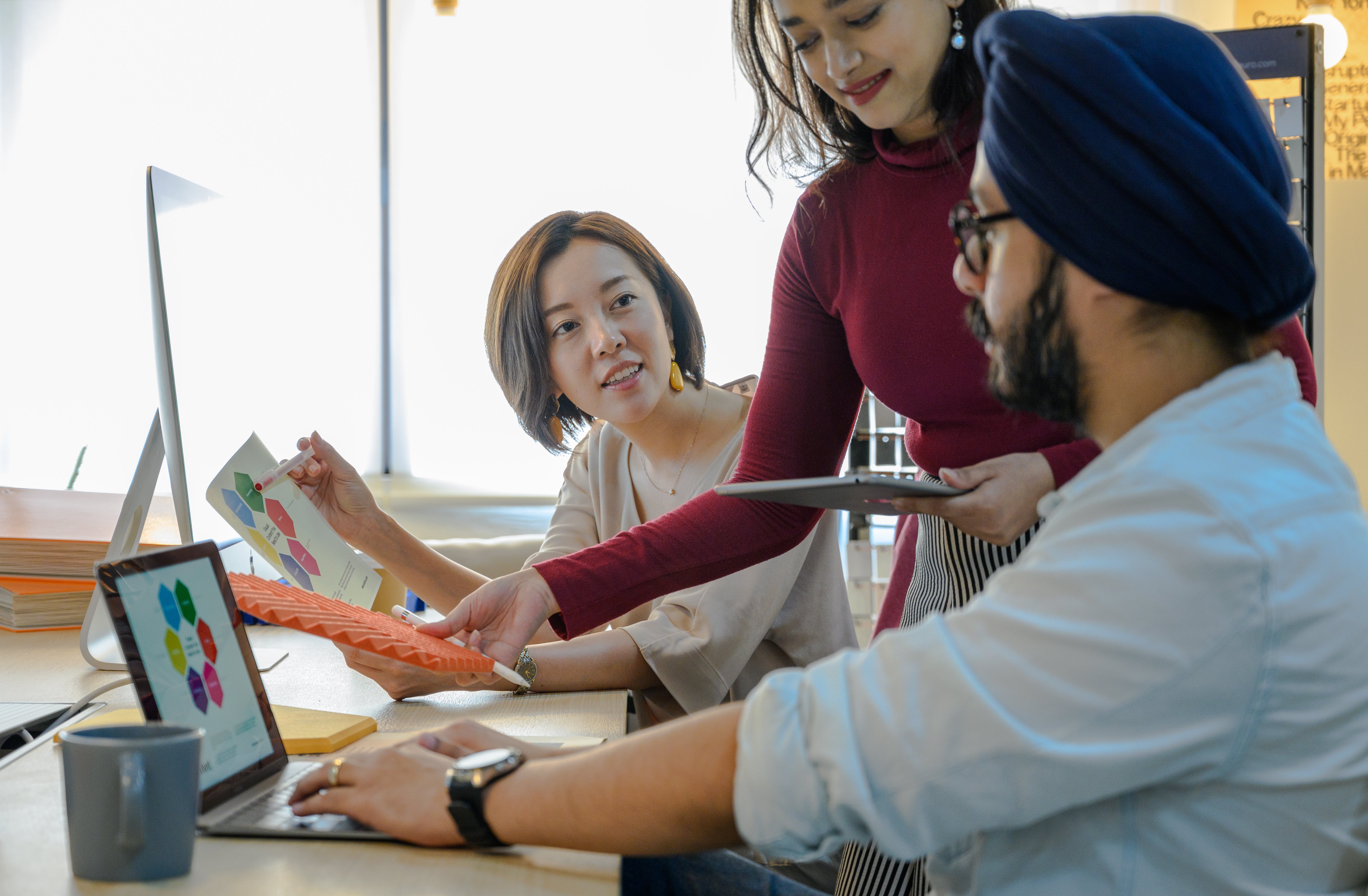 Employees discussing optimal frequency for cold emails