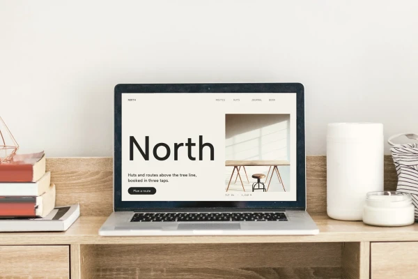 Laptop on an oak desk showing the North website