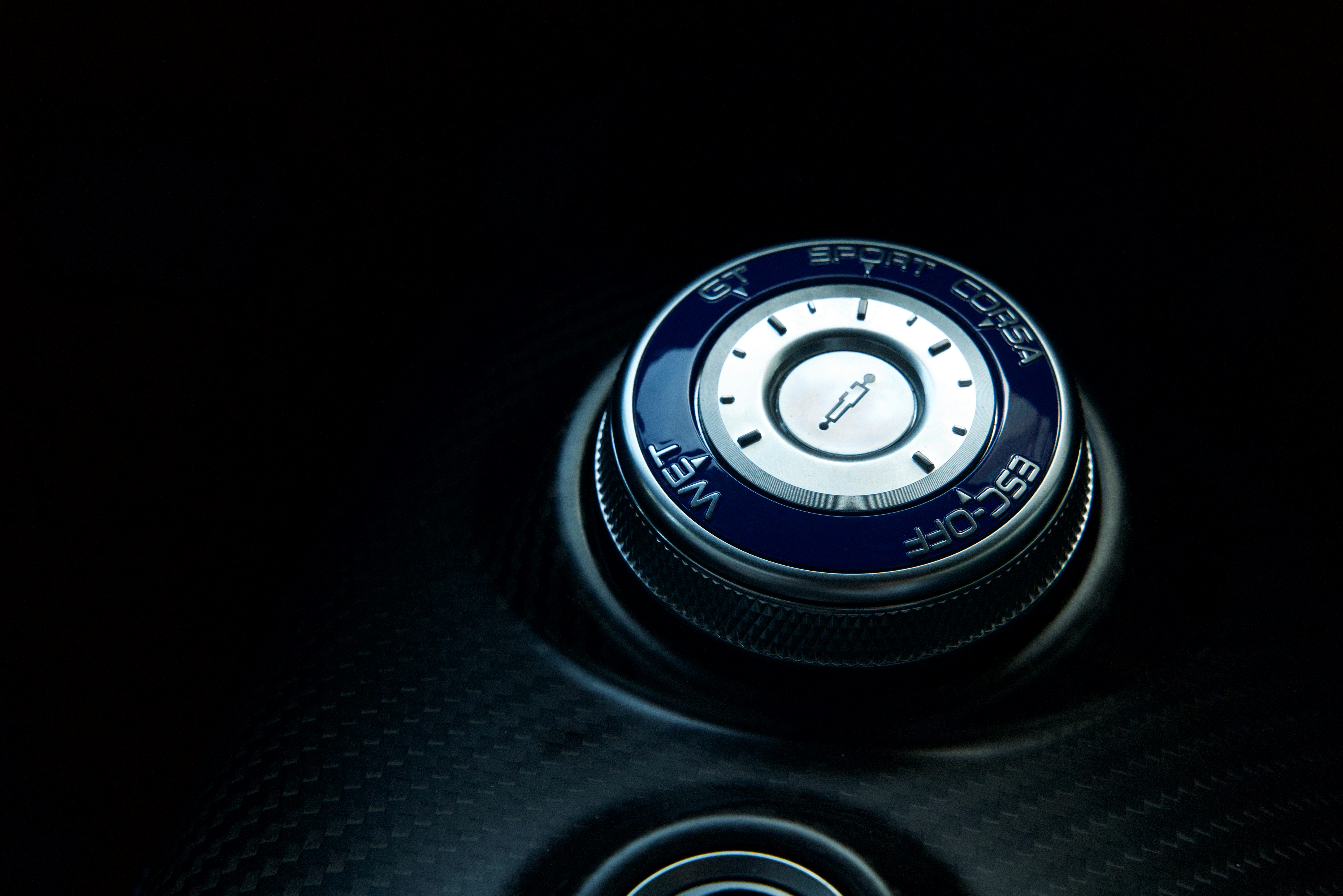a close up of a clock on a black surface