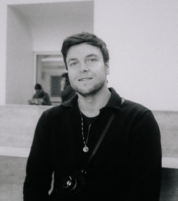 Man wearing white bunny hat with fake glasses and mustache design.