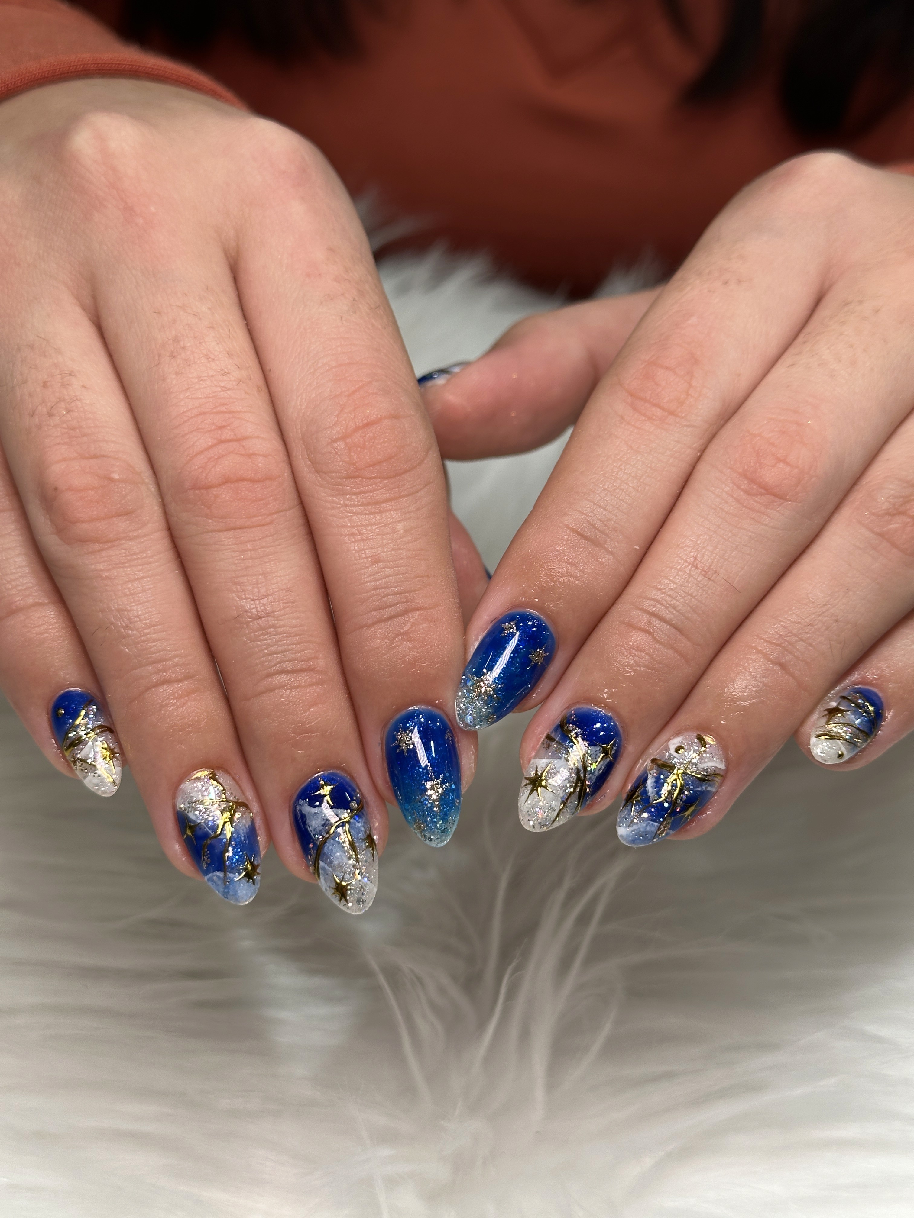 Gel-X nails with blue celestial nail art at premium nail salon Naperville Illinois