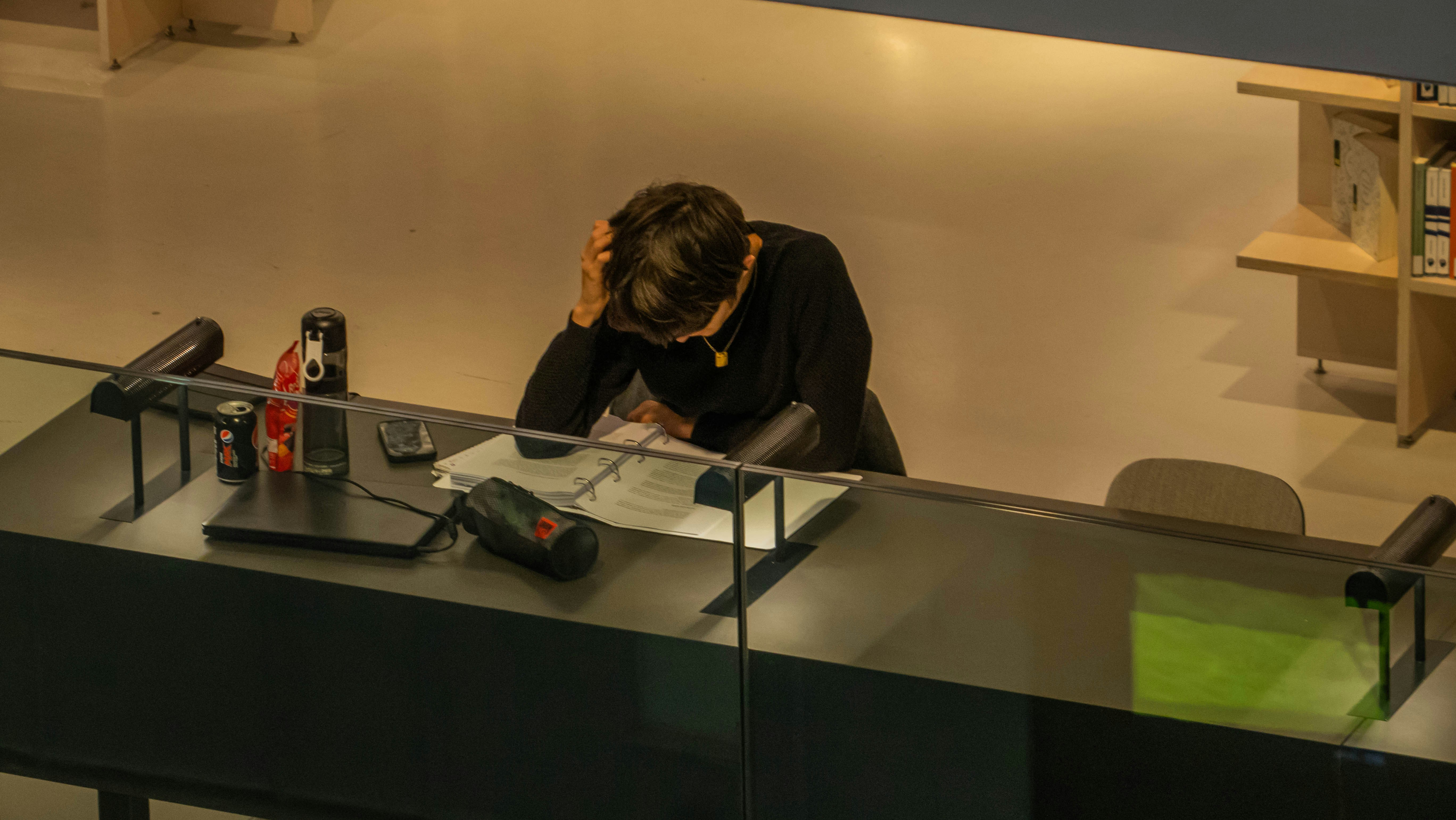 Person reading contract papers at a desk, preparing for a white label deal.
