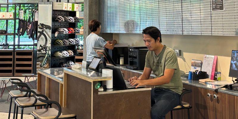 Staff of The Bike Artisans at the counter of their Elmina Lakeside Mall store.