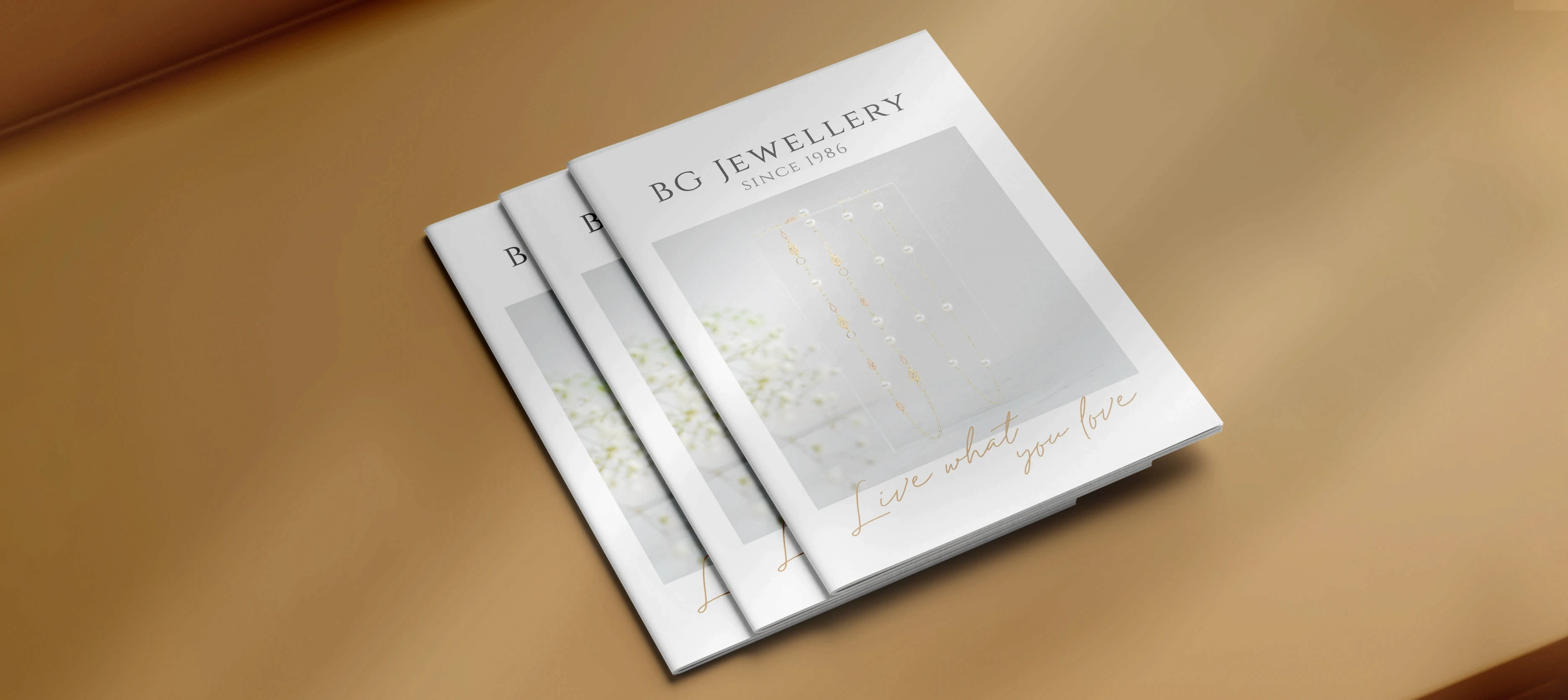 BG Jewellery brochure cover – minimalist grey with elegant gold typography and subtle logo by Teatime Studio.