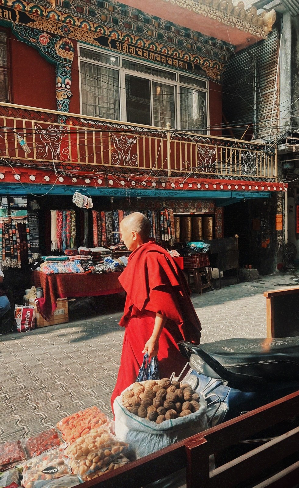 monk walking on the streets of Dharamshala, makleod ganj, reats to india