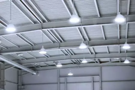 person holding black and yellow nike gloves