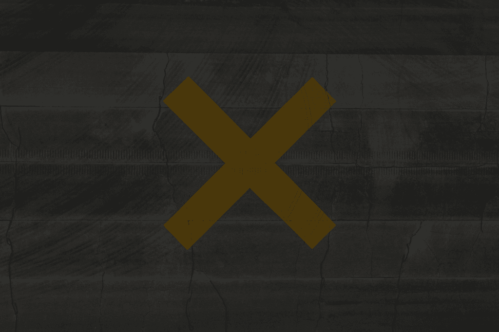 Murvegg med en X – symbol på ansvarsfraskrivelse og begrenset ansvar hos Sideklikk