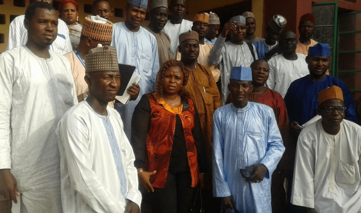 woman in blue hijab sitting on chair