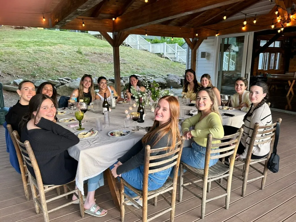 Group dining together on the covered patio at Camp Lenox