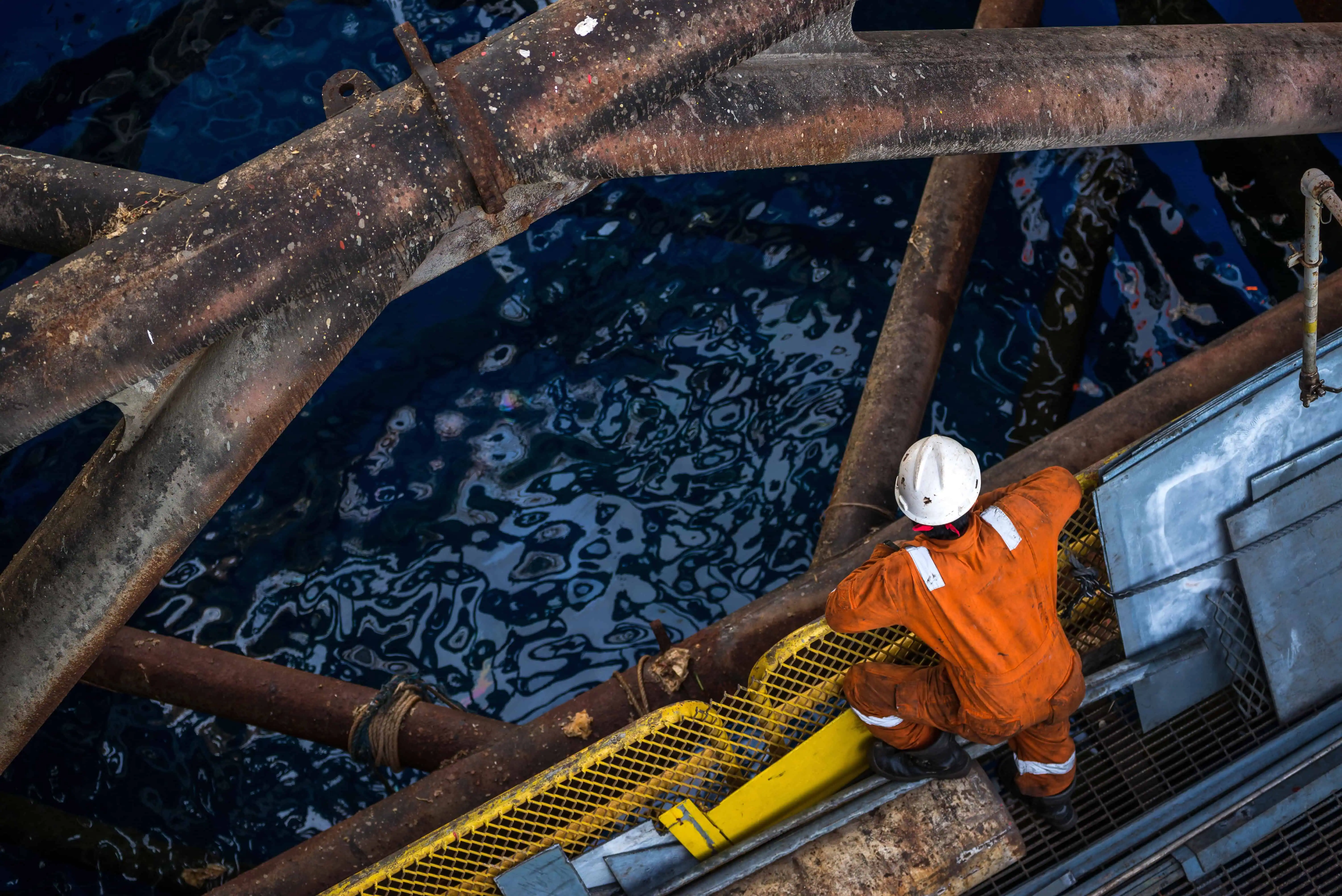 Fatigued worker taking rest on an oil rig during a long shift