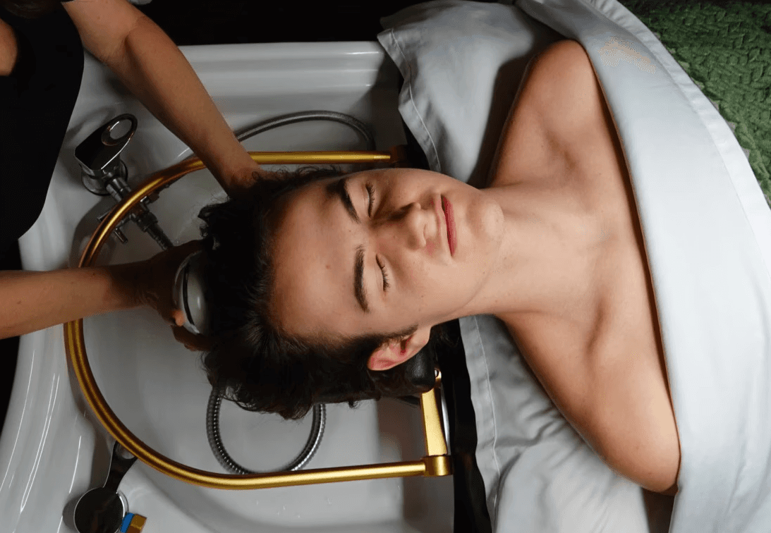 A man receiving a head massage