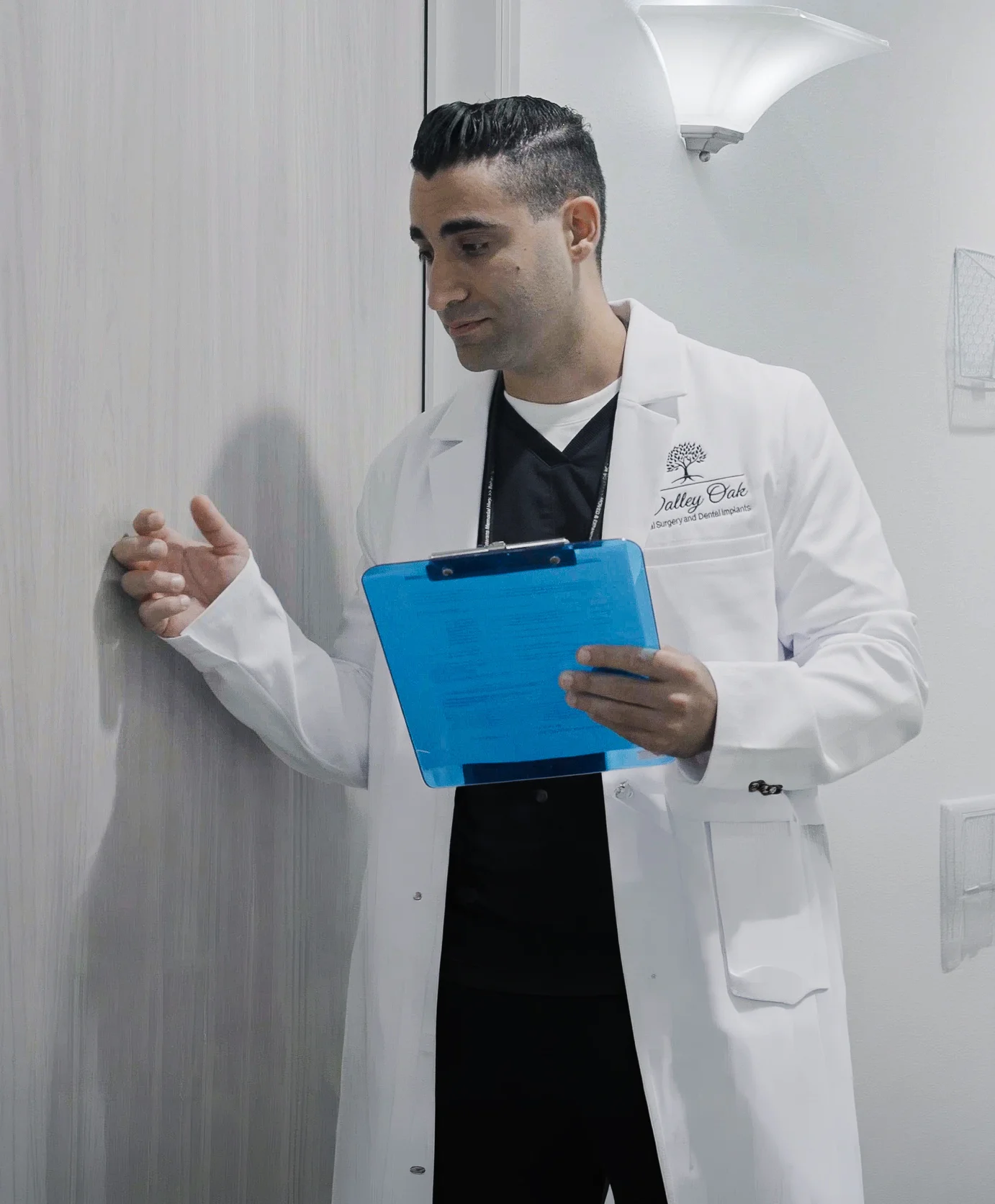 Dr. Justin Nassiri reviewing patient information during a consultation at Valley Oak Oral Surgery in Fresno, CA.