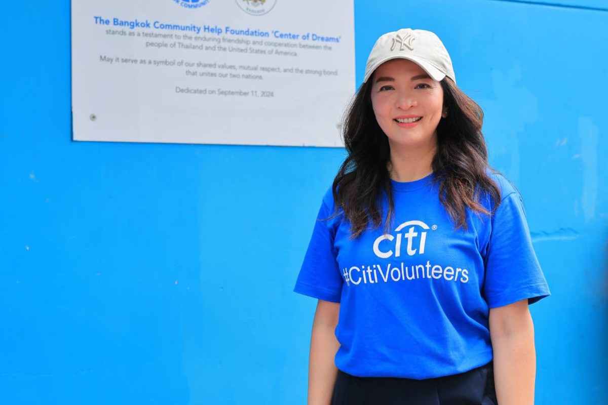 group of children wearing medal standing near wall