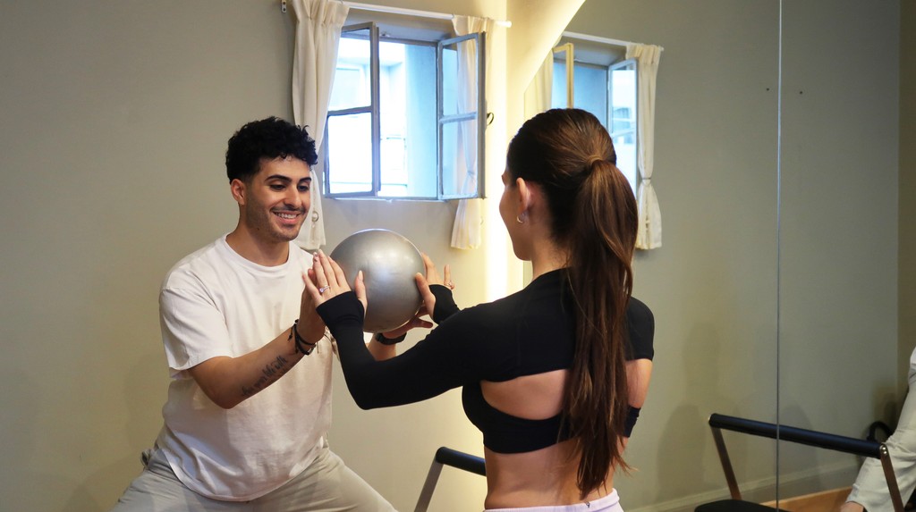 Shirtless man meditating indoors
